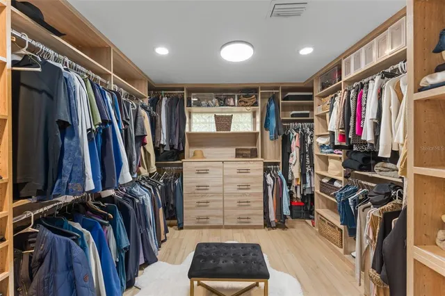 a view of a swimming pool and lounge chairs in back yard of the house