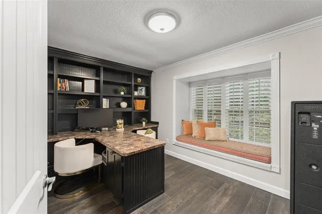 a bedroom with a large bed and a flat tv screen on dresser