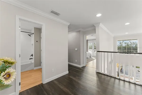 a view of a lake with a big yard and large trees