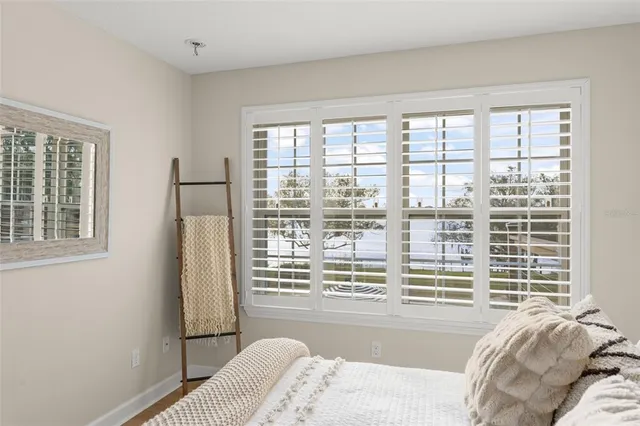 an aerial view of residential houses with outdoor space and trees all around
