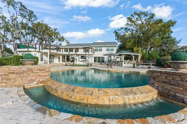 a living room with fireplace furniture and a large window