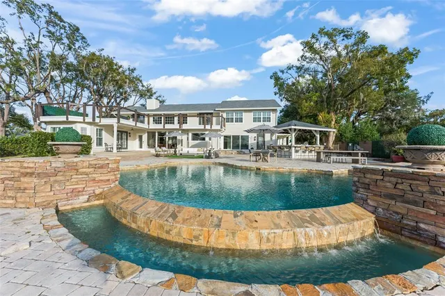 a living room with fireplace furniture and a large window