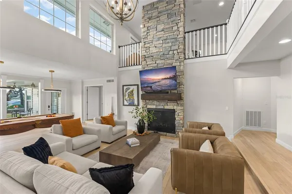 a kitchen with stainless steel appliances a dining table chairs and stove top oven