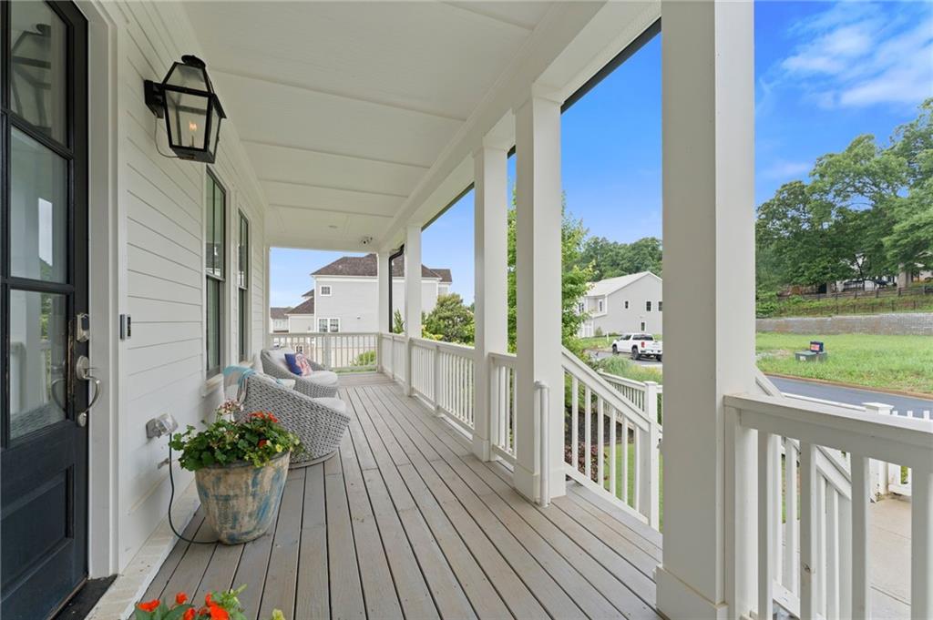 7170 Lullwater Road Cumming, GA 30040 - Photo 3 of 86 a view of a balcony with chair and wooden floor