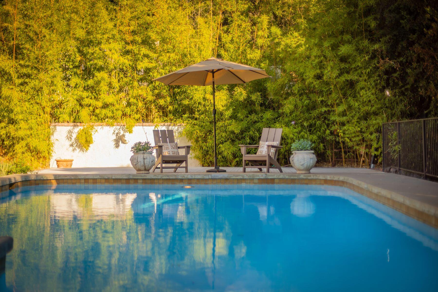 1270 Foothill Road Ojai, CA 93023 - Photo 4 of 47 a small pool with a table and chairs under an umbrella
