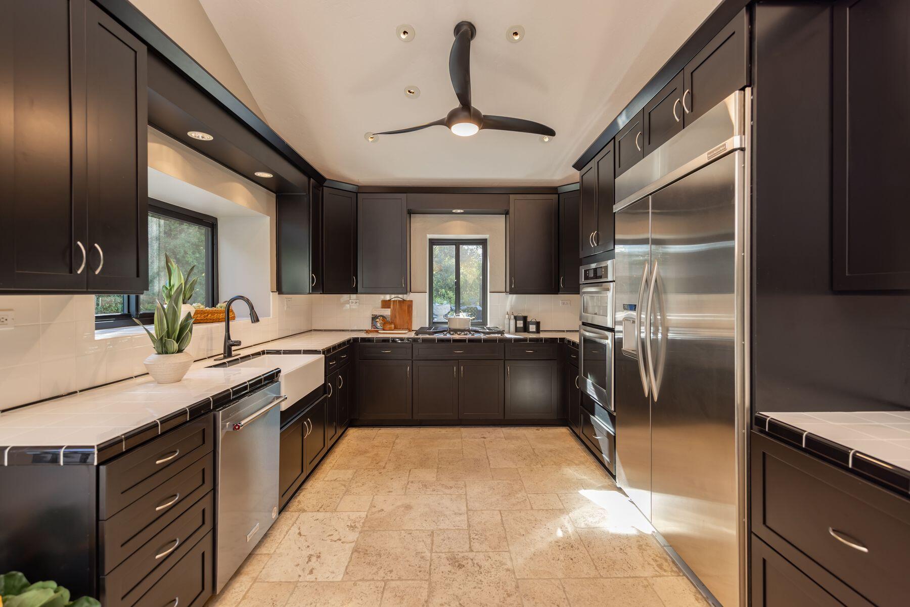 1270 Foothill Road Ojai, CA 93023 - Photo 8 of 47 a kitchen with a sink refrigerator and cabinets