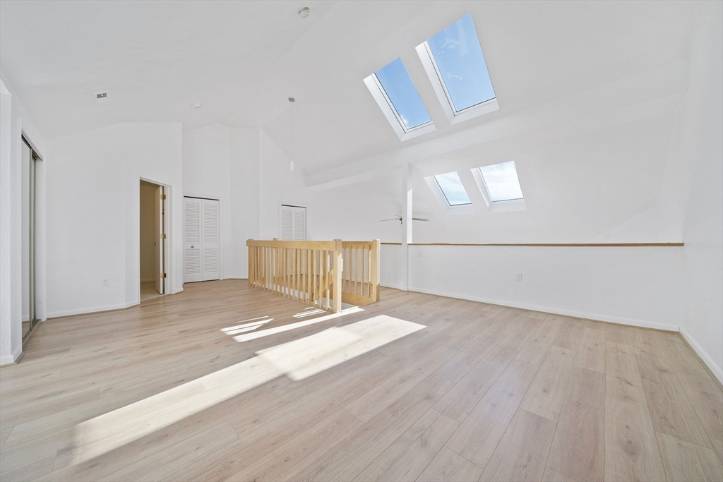 110 Burkhall Street, Unit H Weymouth, MA 02190 - Photo 14 of 18 a view of an empty room with wooden floor