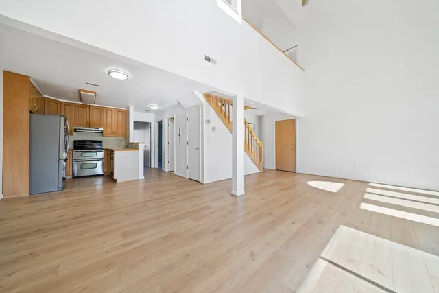 a view of a kitchen with a sink and a refrigerator