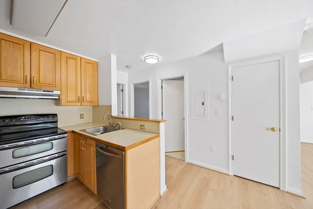 a kitchen that has a sink and a stove in it