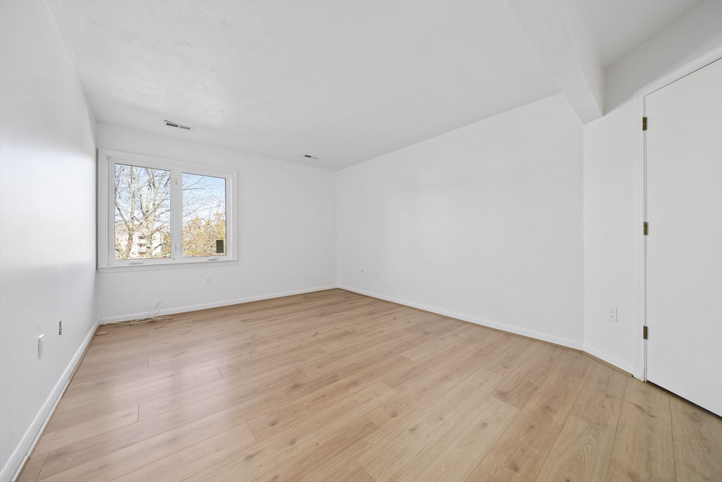 110 Burkhall Street, Unit H Weymouth, MA 02190 - Photo 7 of 18 a view of an empty room with a window