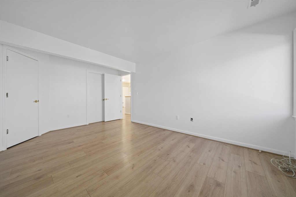 110 Burkhall Street, Unit H Weymouth, MA 02190 - Photo 8 of 18 a view of an empty room with wooden floor