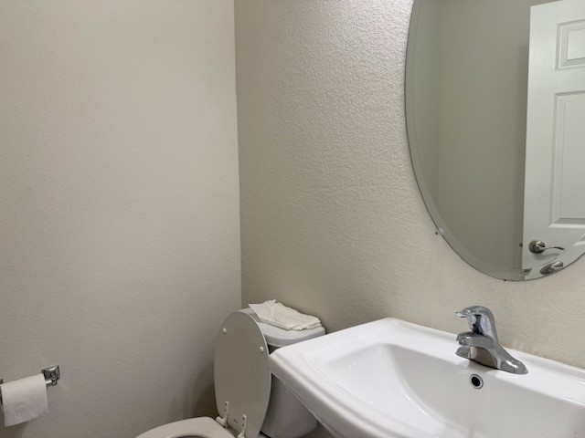2015 Crimson Rosella Trail Austin, TX 78728 - Photo 11 of 20 Bathroom featuring a textured wall and toilet