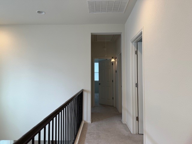 2015 Crimson Rosella Trail Austin, TX 78728 - Photo 13 of 20 Corridor with light colored carpet and attic access