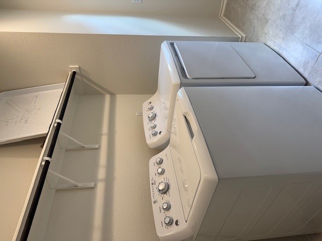 2015 Crimson Rosella Trail Austin, TX 78728 - Photo 16 of 20 Washroom with a textured wall, independent washer and dryer, and light tile patterned flooring