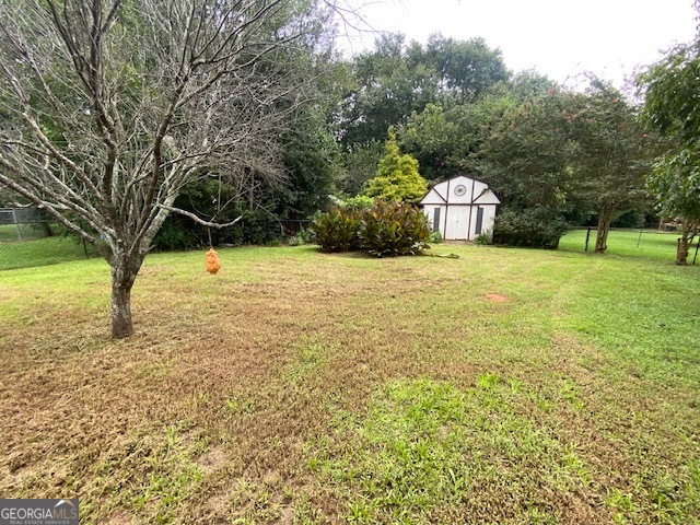 1102 Williams Lane Elberton, GA 30635 - Photo 29 of 36 a tall yellow house with a yard and large trees