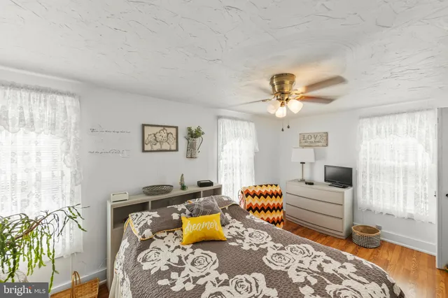 a bedroom with a bed and ceiling fan