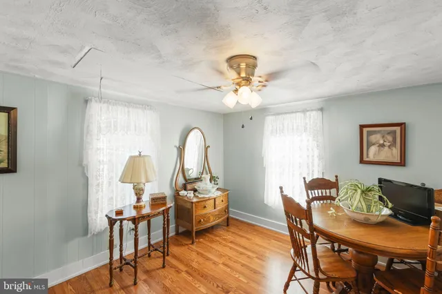 a view of a dining room with furniture wooden floor and a chandelier