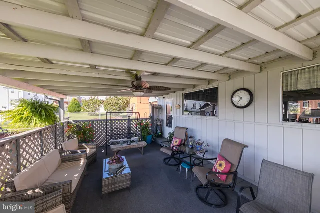 a view of a porch in front of house with a yard