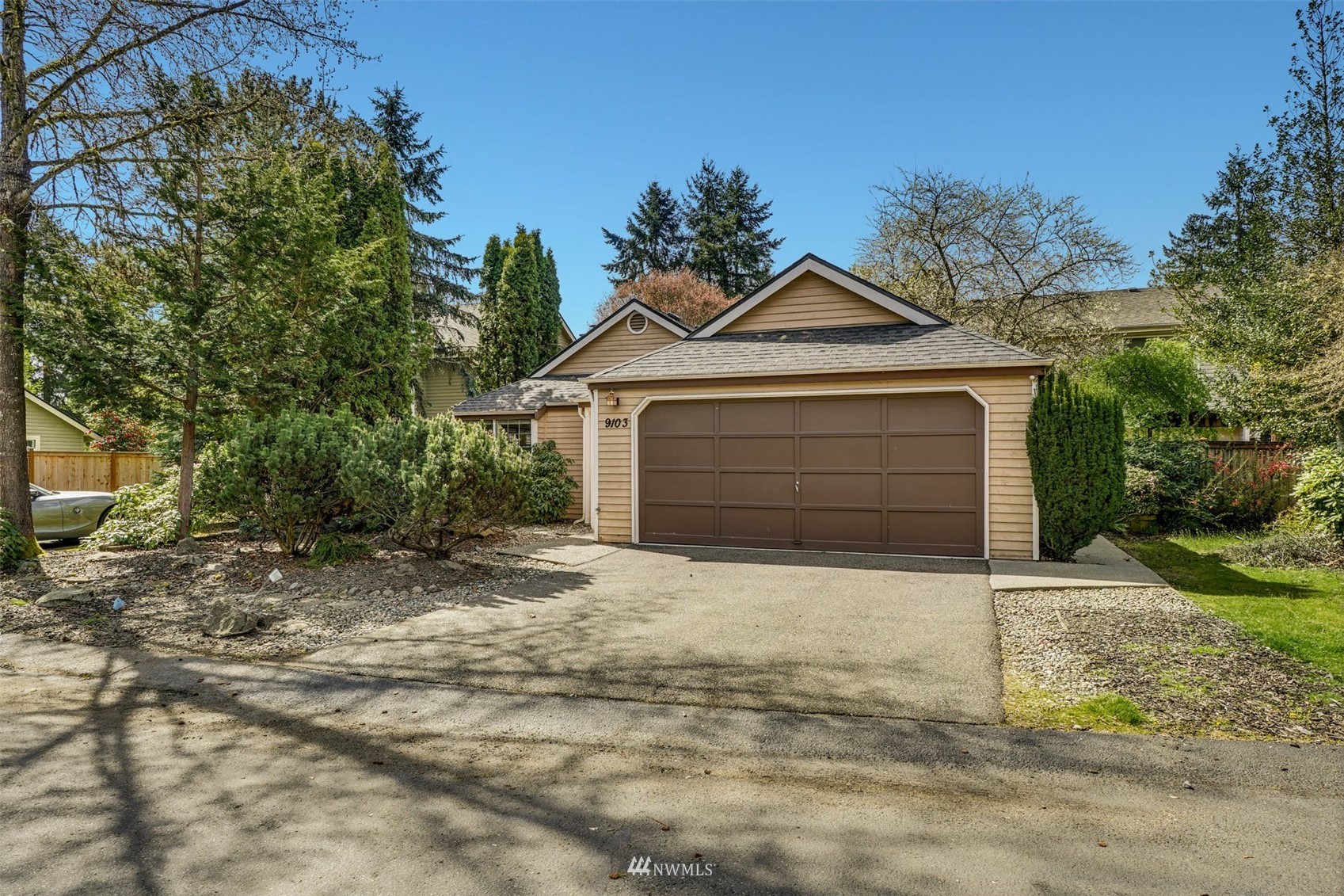9103 183rd Avenue Northeast Redmond, WA 98052 - Photo 1 of 25 a front view of a house with a yard and garage