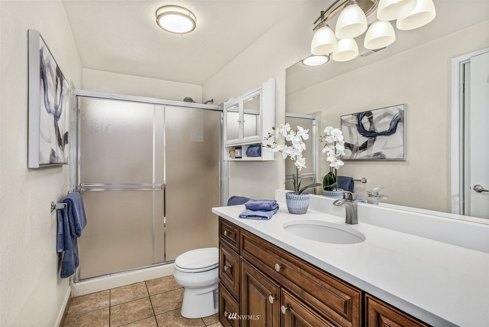 9103 183rd Avenue Northeast Redmond, WA 98052 - Photo 14 of 25 a bathroom with a sink a toilet and a mirror