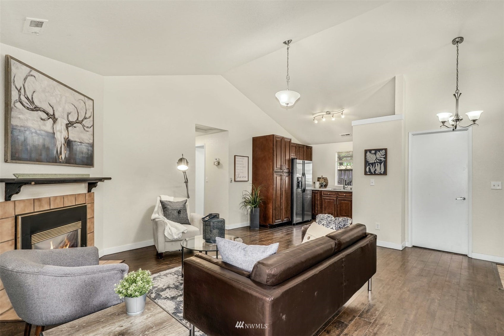 9103 183rd Avenue Northeast Redmond, WA 98052 - Photo 6 of 25 a living room with furniture a fireplace and a flat screen tv