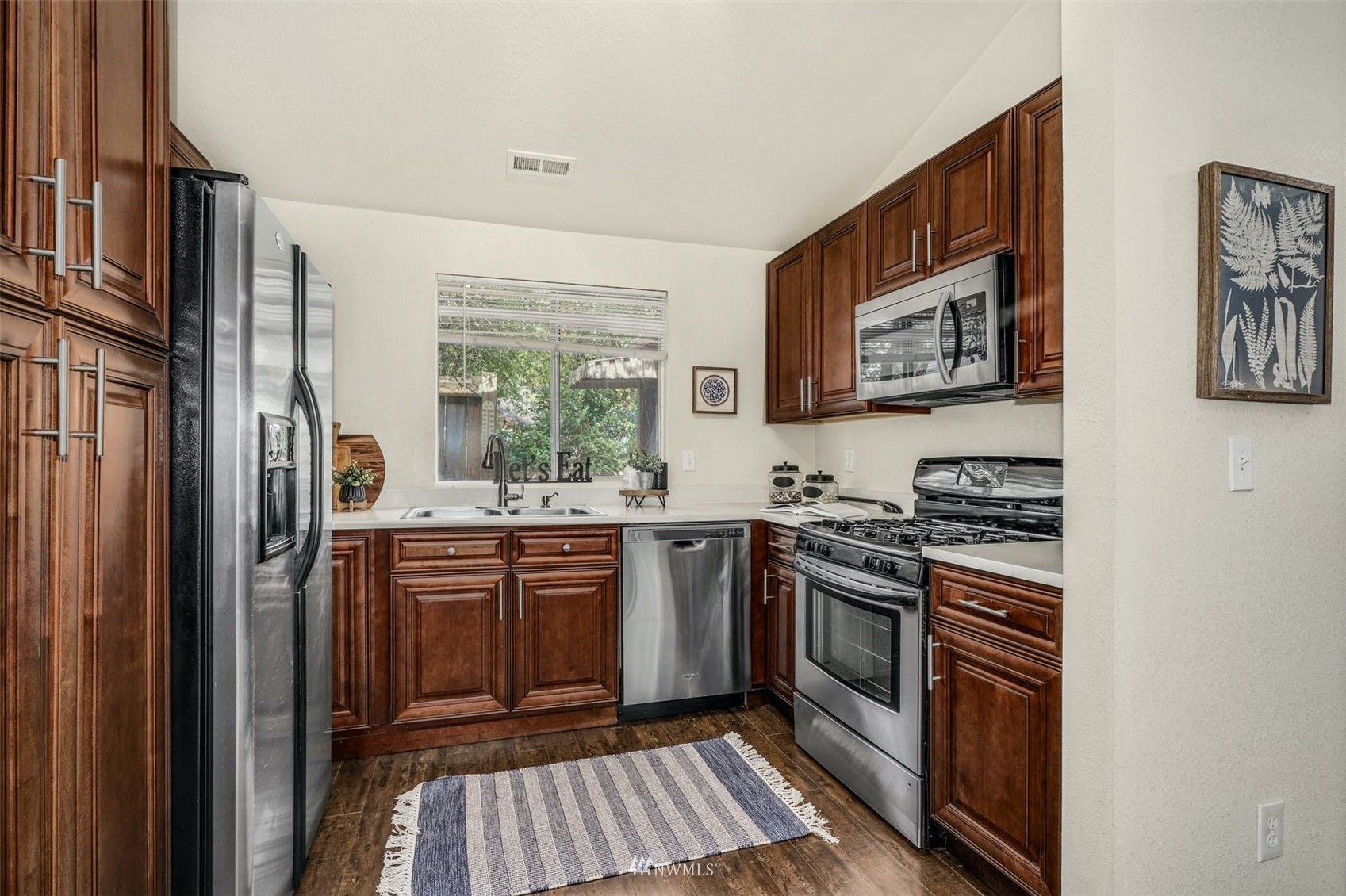9103 183rd Avenue Northeast Redmond, WA 98052 - Photo 9 of 25 a kitchen with stainless steel appliances granite countertop a stove top oven