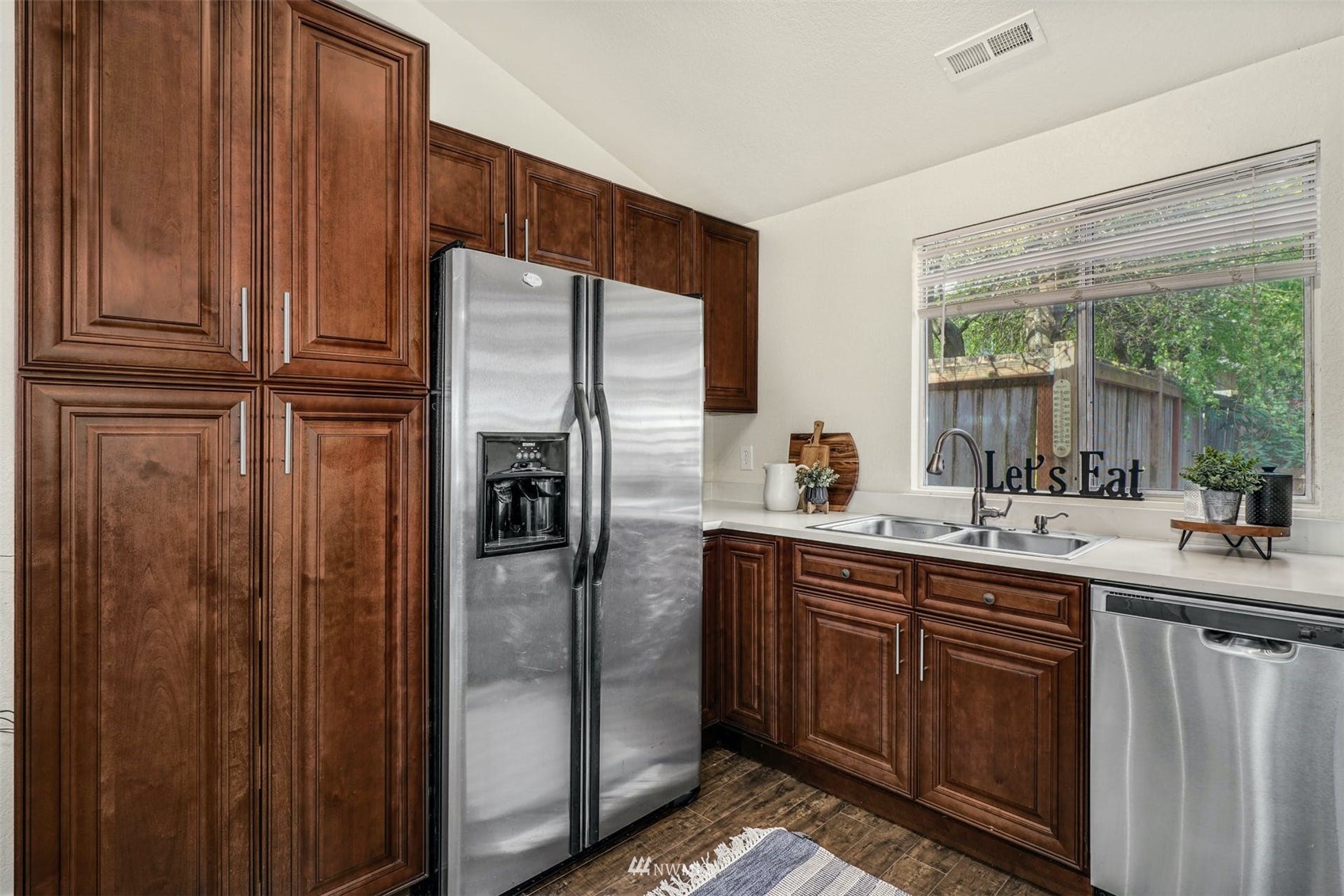 9103 183rd Avenue Northeast Redmond, WA 98052 - Photo 10 of 25 a kitchen with stainless steel appliances granite countertop a refrigerator and a sink