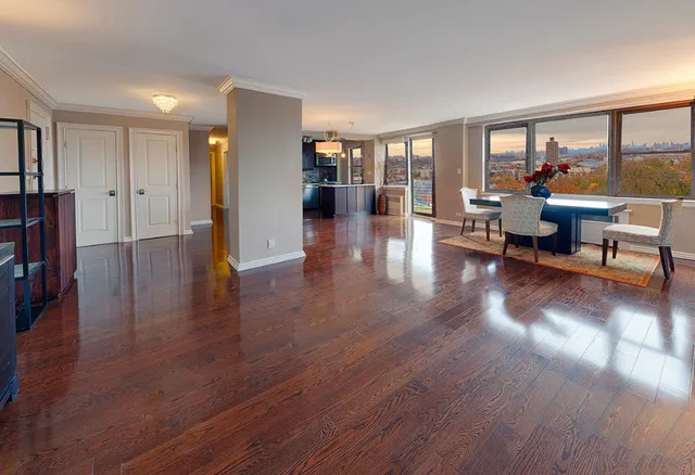 a view of a livingroom with furniture hardwood floor and a large window