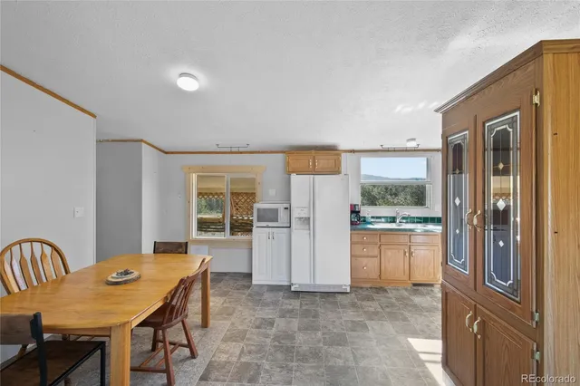 a kitchen with a sink window and cabinets
