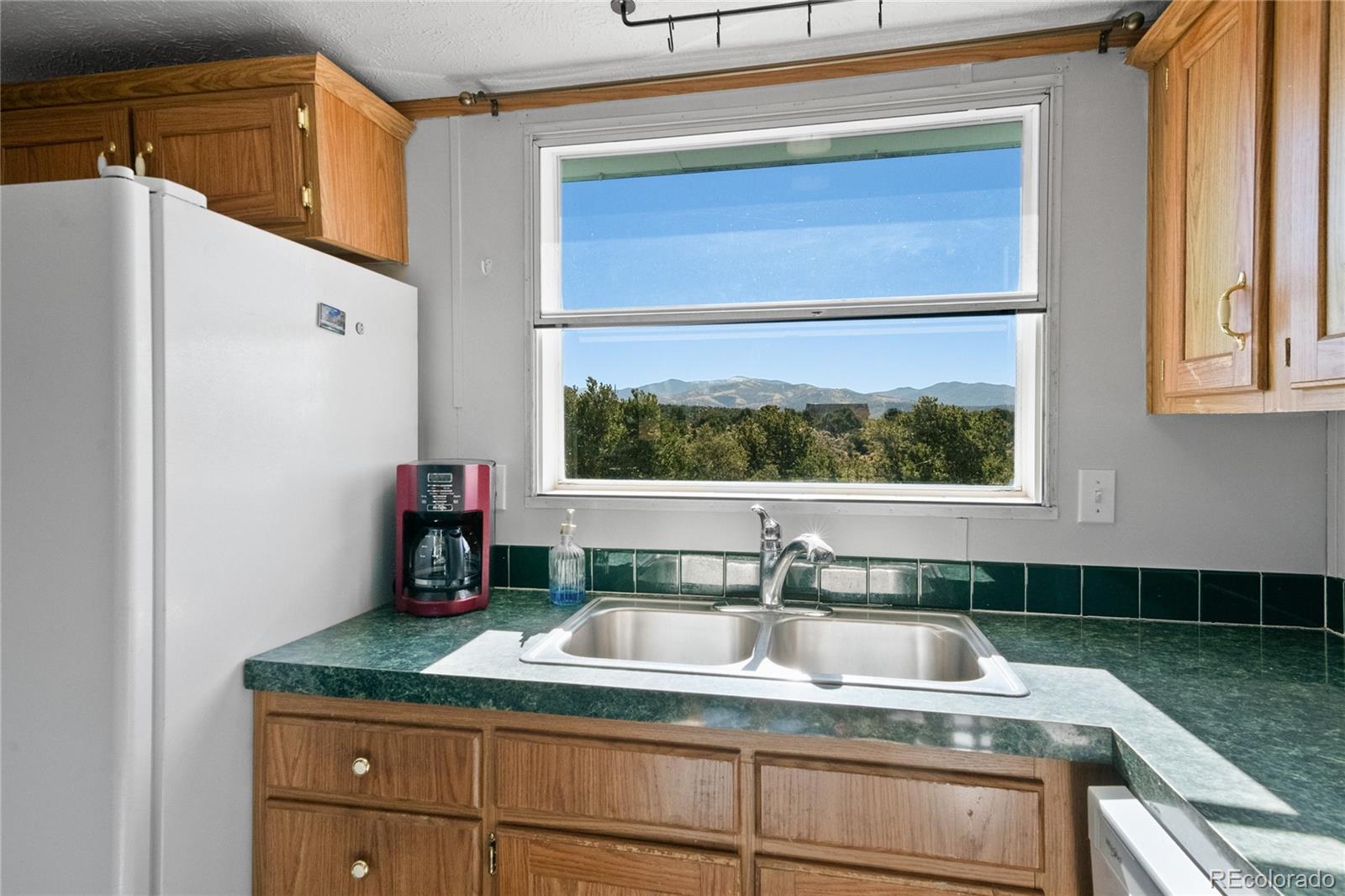 7027 Frelinghuysen Road Fort Garland, CO 81133 - Photo 18 of 47 a kitchen with a sink and a window