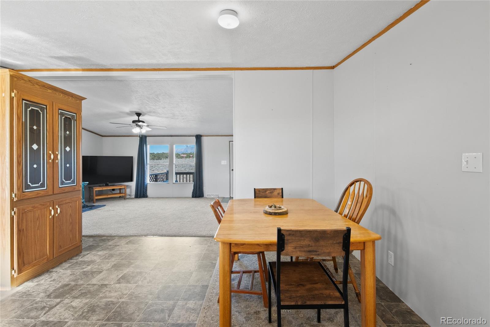 7027 Frelinghuysen Road Fort Garland, CO 81133 - Photo 21 of 47 a view of a dining room with furniture and wooden floor