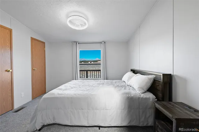 a bedroom with a bed and cabinets