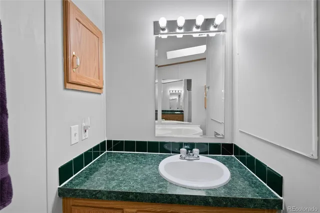 a bathroom with a tub and mirror