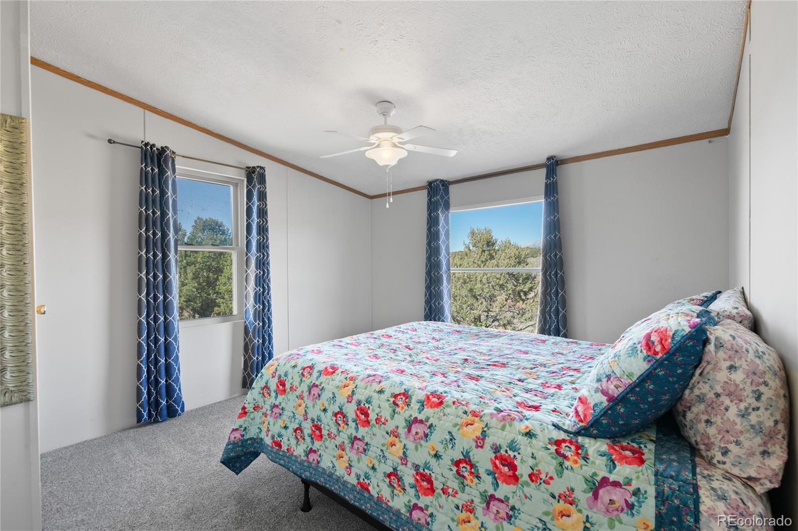 7027 Frelinghuysen Road Fort Garland, CO 81133 - Photo 30 of 47 a bedroom with a bed and a window with chair