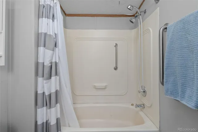 a bedroom with two beds and a chandelier