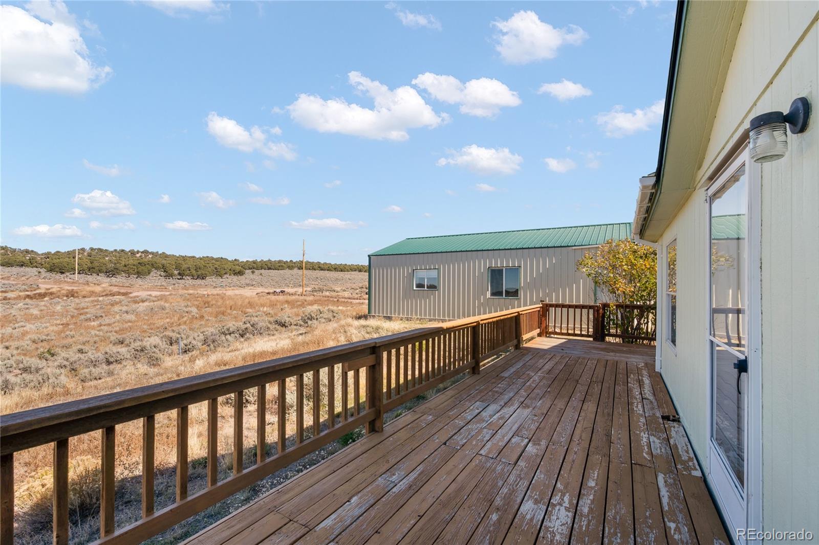 7027 Frelinghuysen Road Fort Garland, CO 81133 - Photo 38 of 47 a view of a balcony with wooden floor