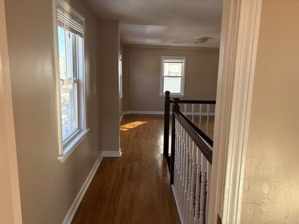 14 B School, Unit 2 Boston, MA 02124 - Photo 14 of 18 a view of a hallway with wooden floor and stairs