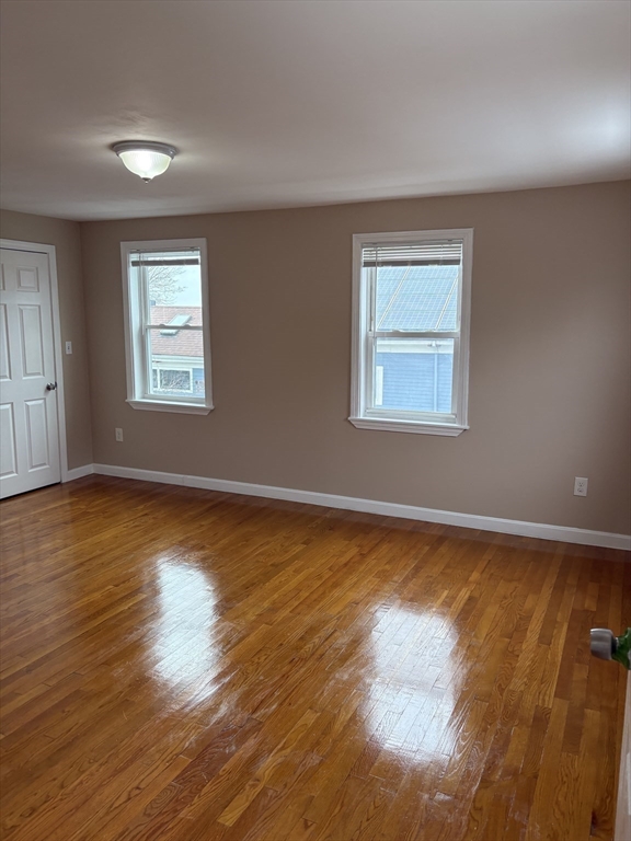 14 B School, Unit 2 Boston, MA 02124 - Photo 9 of 18 a view of an empty room with wooden floor and a window