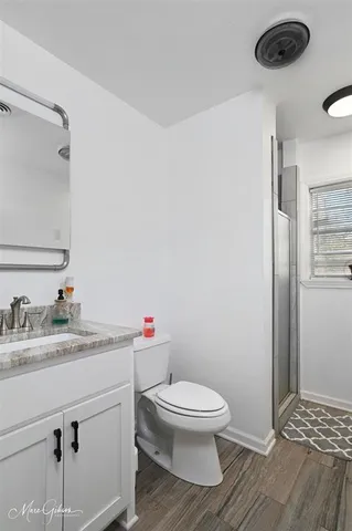 a white toilet sitting next to a bathroom sink