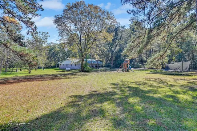 a view of outdoor space with swimming pool and green space