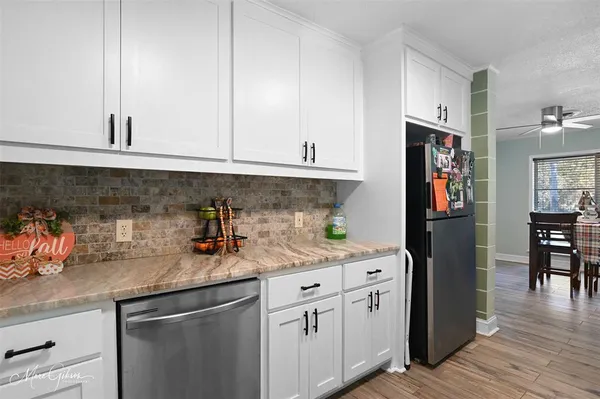 a kitchen with stainless steel appliances granite countertop a refrigerator and a sink