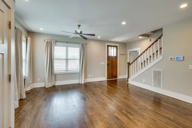 a view of an entryway with wooden floor and stairs
