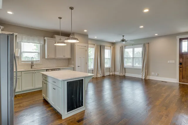 a kitchen with a stove a sink and a refrigerator