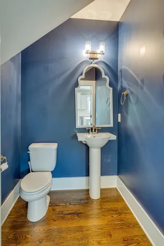a bathroom with a toilet sink and mirror