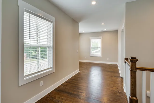 a view of a room with wooden floor and window