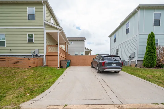a car parked in front of white house