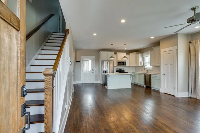 a view of kitchen with wooden floor and electronic appliances
