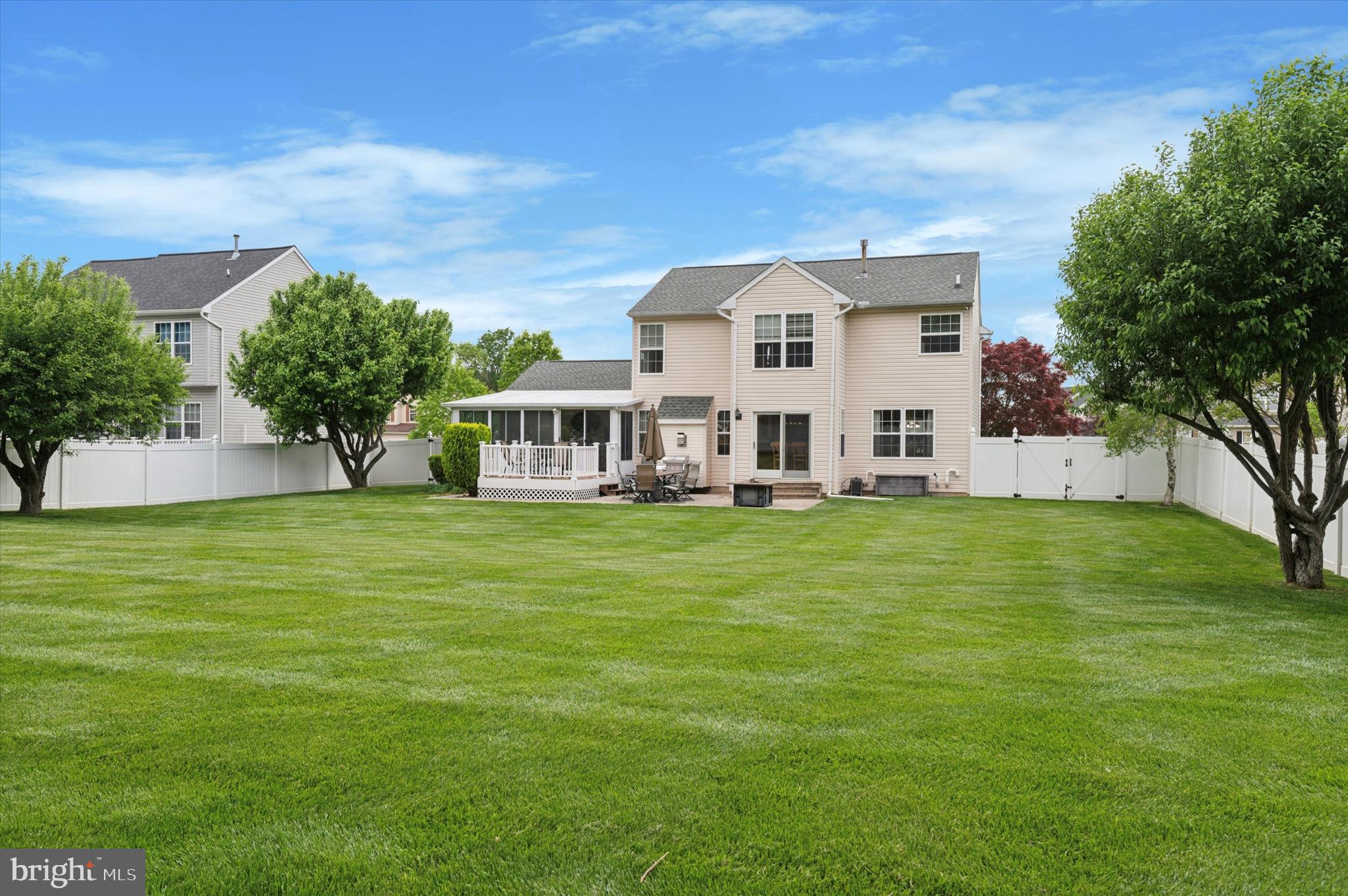 6 Crestpoint Drive New Castle, DE 19720 - Photo 35 of 36 a view of a white house with a big yard and potted plants