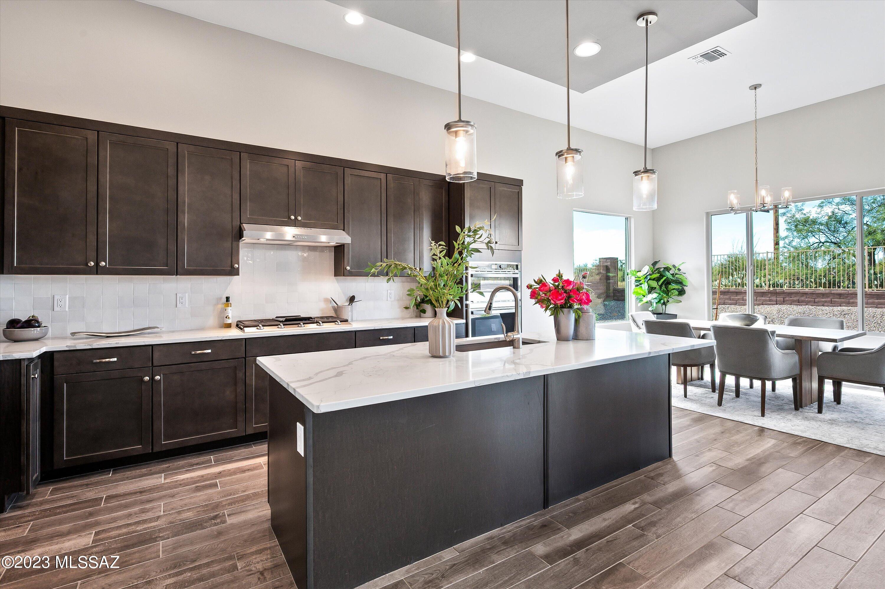13169 North Vistoso Rnch Place Oro Valley, AZ 85755 - Photo 7 of 29 a kitchen with lots of counter top space and wooden floor