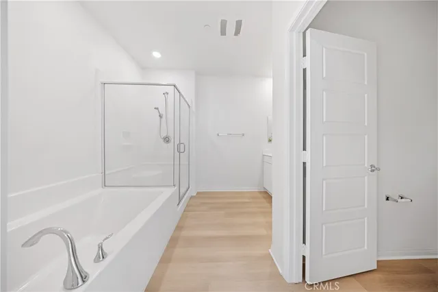 a bathroom with a tub shower and sink